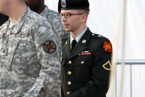 Army Pfc. Bradley Manning, in handcuffs, is escorted out of a courthouse in Fort Meade, Maryland