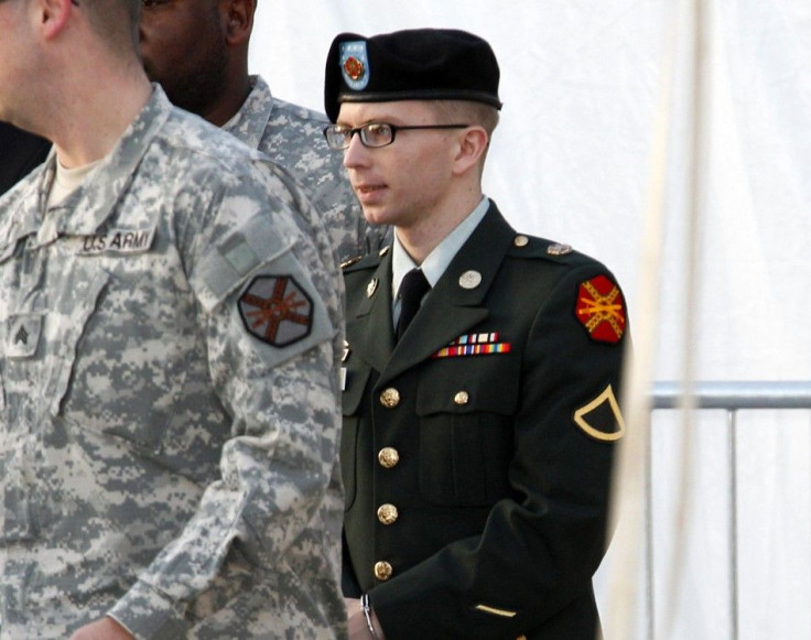 Army Pfc. Bradley Manning, in handcuffs, is escorted out of a courthouse in Fort Meade, Maryland