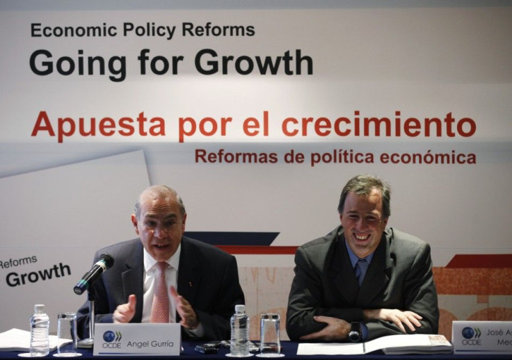 Secretary-General of the Organization for Economic Cooperation and Development (OECD) Angel Gurria (L) speaks next to Mexican Finance Minister Jose Antonio Meade, on the sidelines of the meeting of finance ministers and central bank governors of the group