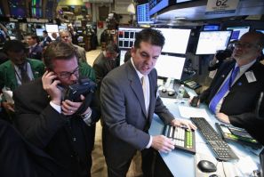 Specialist David Haubner (C) gives prices for the IPO of Proto Labs on the floor of the New York Stock Exchange February 24, 2012.