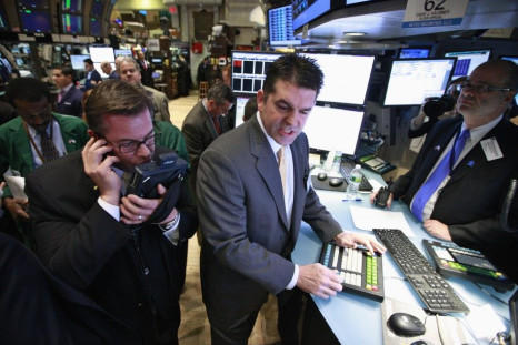Specialist David Haubner (C) gives prices for the IPO of Proto Labs on the floor of the New York Stock Exchange February 24, 2012.