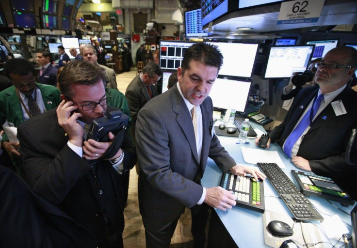 Specialist David Haubner (C) gives prices for the IPO of Proto Labs on the floor of the New York Stock Exchange February 24, 2012.