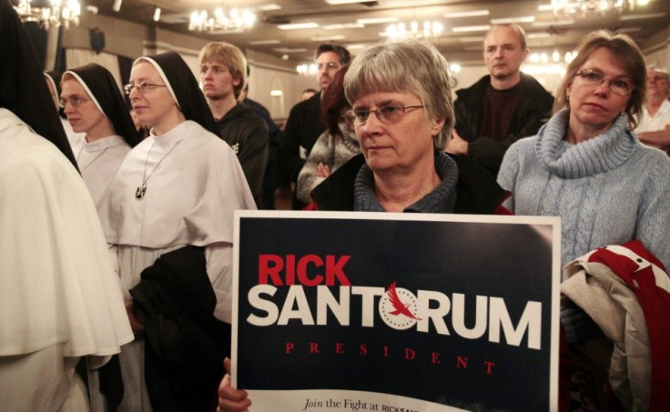 Supporters of U.S. Republican presidential candidate Rick Santorum listen his speech during a campaign stop at a Knights of Columbus hall in Lincoln Park, Michigan February 24, 2012.