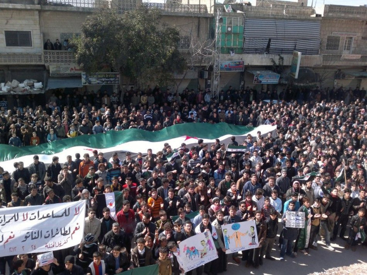 Demonstrators hold a large Syrian opposition flag during a protest against Syria's President Bashar al-Assad in Kafranbel near Idlib February 24, 2012.