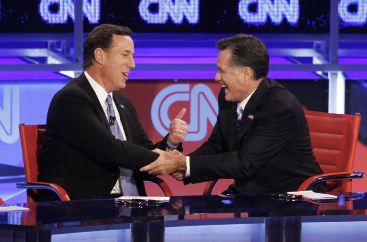 U.S. Republican presidential candidates, former U.S. Senator Rick Santorum and former Massachusetts Governor Mitt Romney (R) laugh as they shake hands at the conclusion of the Republican presidential candidates debate in Mesa, Arizona, Feb. 22, 2012.