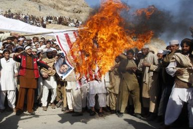 Afghan protesters burn a U.S. flag during a protest in Jalalabad province February 24, 2012.