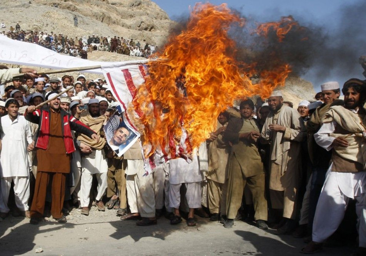 Afghan protesters burn a U.S. flag during a protest in Jalalabad province February 24, 2012.