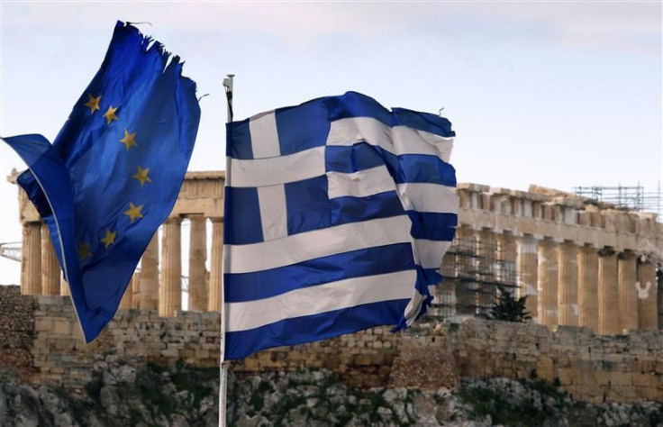 A Greek and an EU flag fly over the Greek ministry of finance in Athens