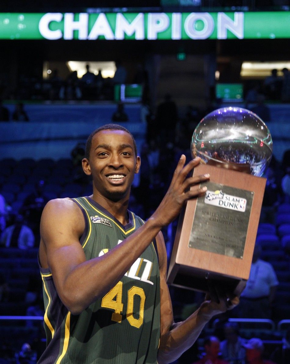 Utah Jazz Evans holds the trophy after winning the slam dunk contest during the NBA All-Star weekend in Orlando 