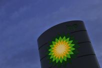 A BP petrol station sign is seen at dawn in west London