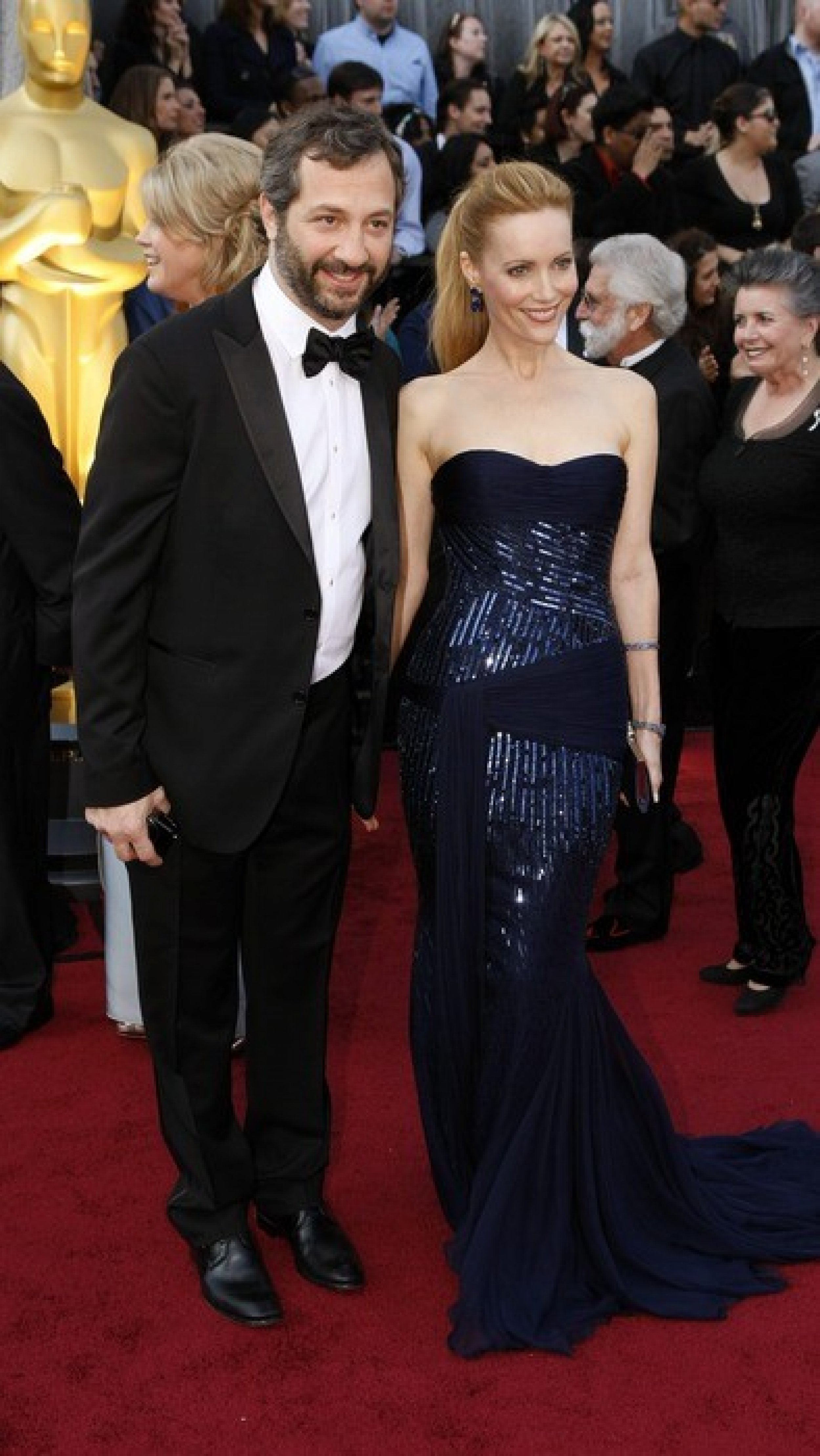 Judd Apatow and Leslie Mann arrive at the 84th Academy Awards.