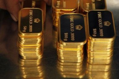 Gold stayed nearly flat in thin trade on Friday, on track to log declines for two of the past three weeks as investors took to the sidelines ahead of a key U.S. option expiration and a Federal Reserve policy meeting next week.