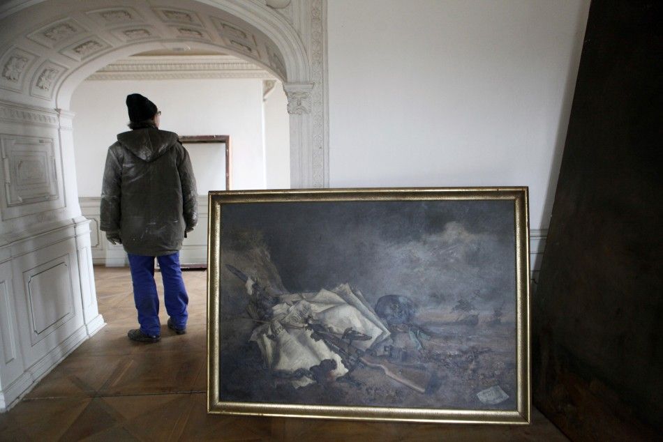 A worker stands next to a painting by German painter Reumann at the Doksany Monastery near Prague