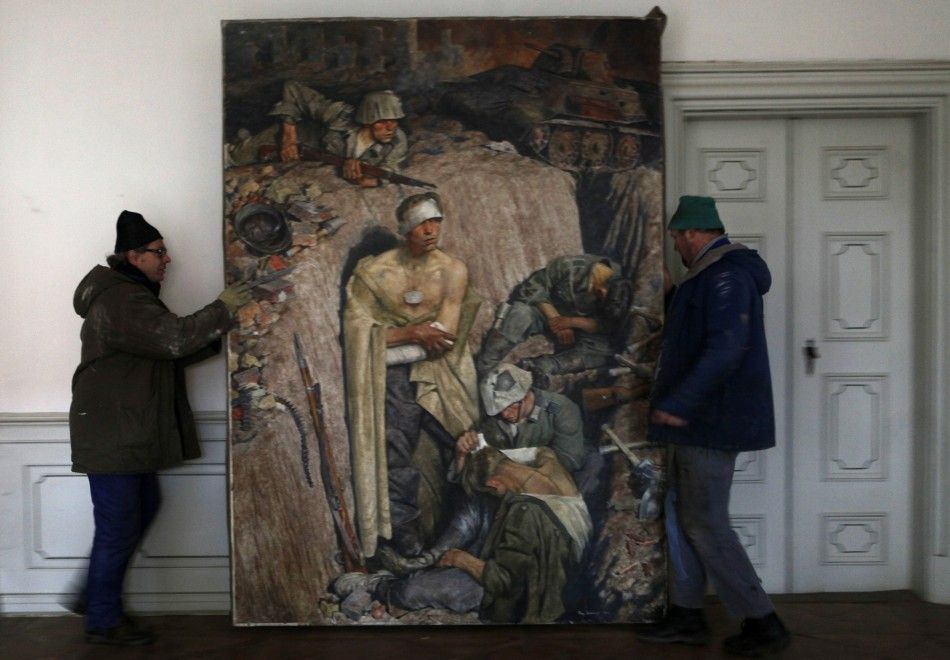 Workers move a 1943 painting by German painter Eichhorst at the Doksany Monastery near Prague