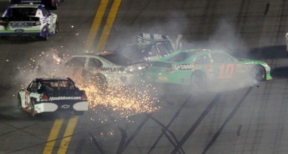 Johnson in his number 48 Chevrolet, Ragan in his number 34 Ford and Patrick in her number 10 Chevrolet crash as Busch in his number 51 Chevrolet tries to avoid them in the early running of the NASCAR Sprint Cup Series 54th Daytona 500 in Daytona Beach