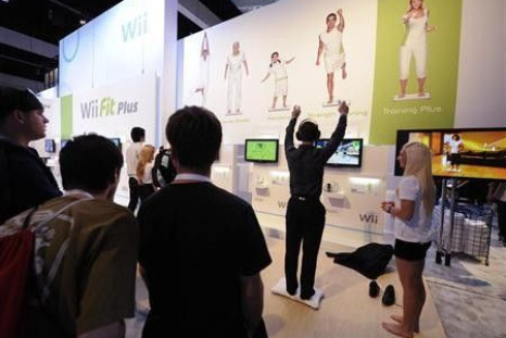 Attendees play Wii Fit Plus at the E3 Electronic Entertainment Expo in Los Angeles June 2, 2009.