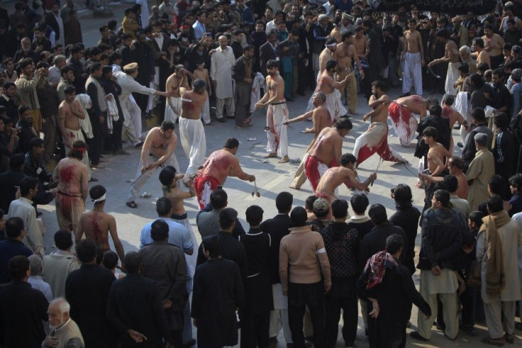 Shi&#039;ite Muslim men take part in self-flagellation during a religious procession ahead of the Ashura festival in Peshawar