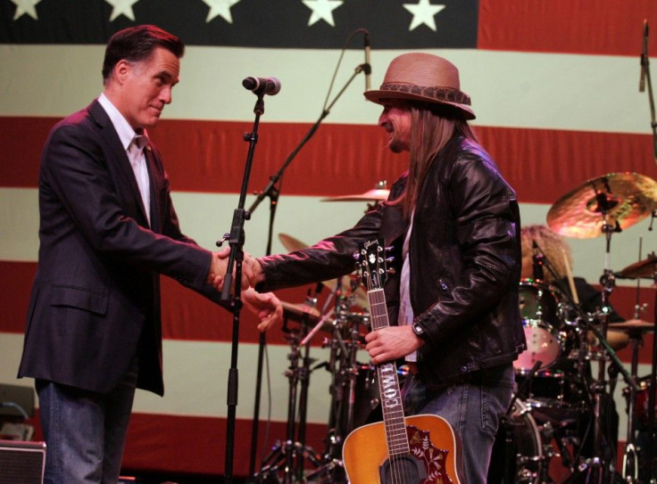 Republican presidential candidate Mitt Romney shakes hands with musician Kid Rock after Rock performed at a campaign stop for Romney's supporters in Royal Oak