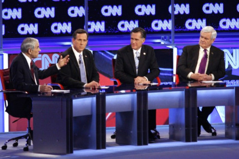U.S. Republican presidential candidate Paul speaks as Santorum, Romney and Gingrich listen during the Republican presidential candidates debate in Mesa