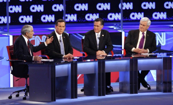 U.S. Republican presidential candidate Paul speaks as Santorum, Romney and Gingrich listen during the Republican presidential candidates debate in Mesa