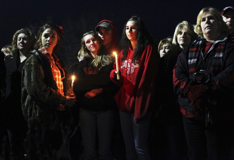 People gather outside St. Mary039s of Chardon for a candlelight vigil remembering the victims of a school shooting in Chardon, Ohio