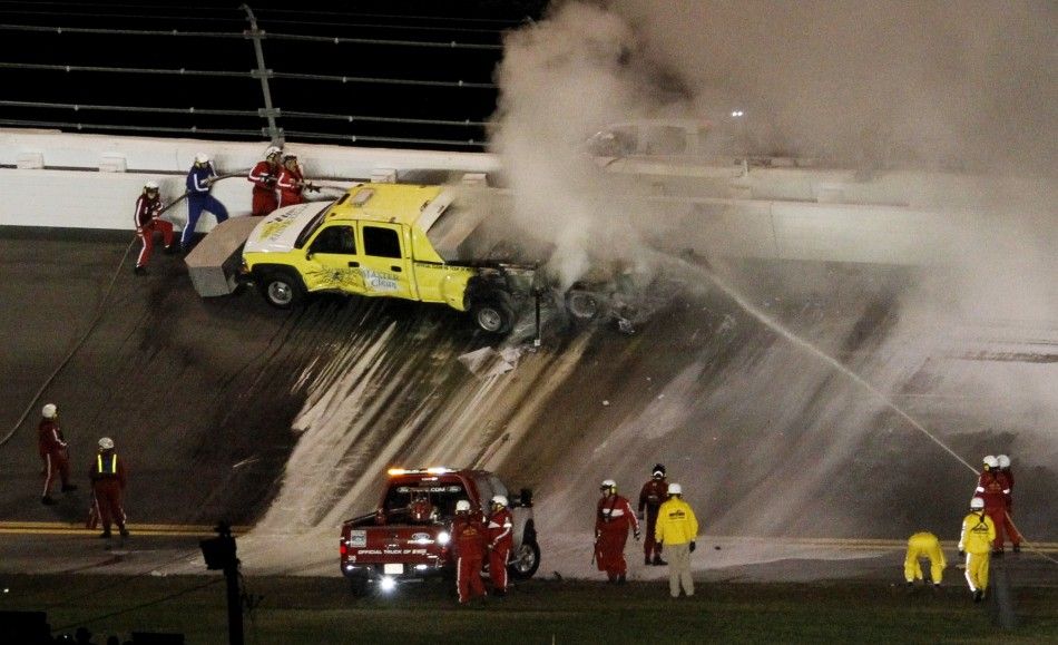 Firefighters battle flames which erupted from a jet dryer after it was hit by Juan Pablo Montoya of Colombia in his number 42 Chevrolet during the NASCAR Sprint Cup Series 54th Daytona 500 race at the Daytona International Speedway in Daytona Beach