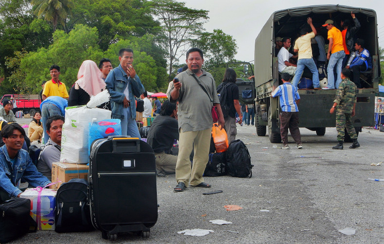Indonesian illegal immigrants wait before being transported to a jetty at Port Klang, outside Kuala Lumpur.