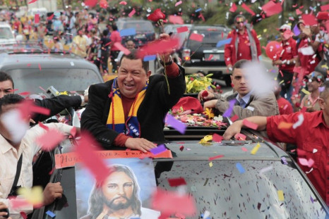 Venezuela&#039;s President Hugo Chavez greets supporters on his way to the airport, before his departure to Cuba in Caracas