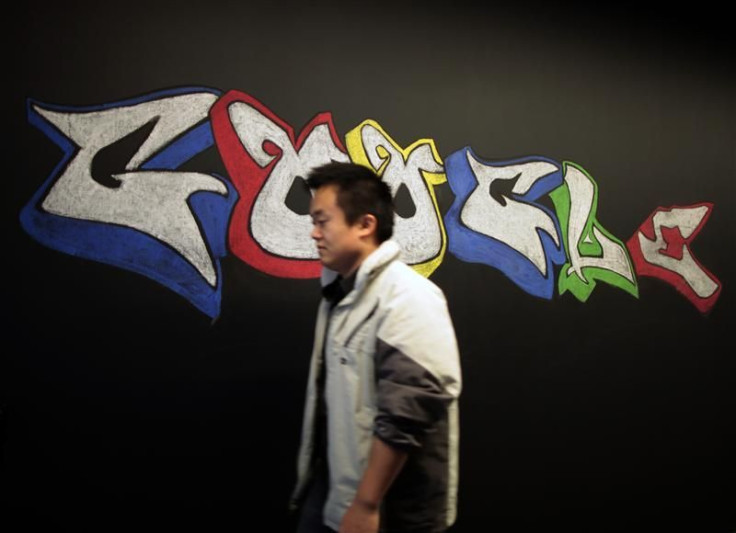 A man walks past a Google logo drawn with chalk on a wall at the Google campus near Venice Beach, in Los Angeles