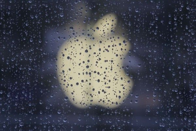 Raindrops are seen in front of an Apple logo outside an Apple store in Shanghai