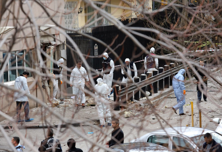 Turkish police forensic experts inspect the site after an explosion at the entrance of the U.S. embassy in Ankara February 1, 2013.