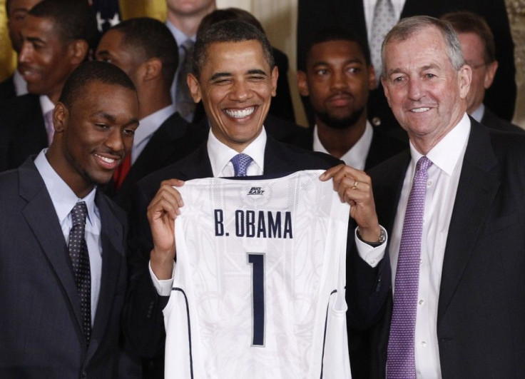The Connecticut men&#039;s basketball team presents Barack Obama with a jersey as they visit the While House after winning the national championship.