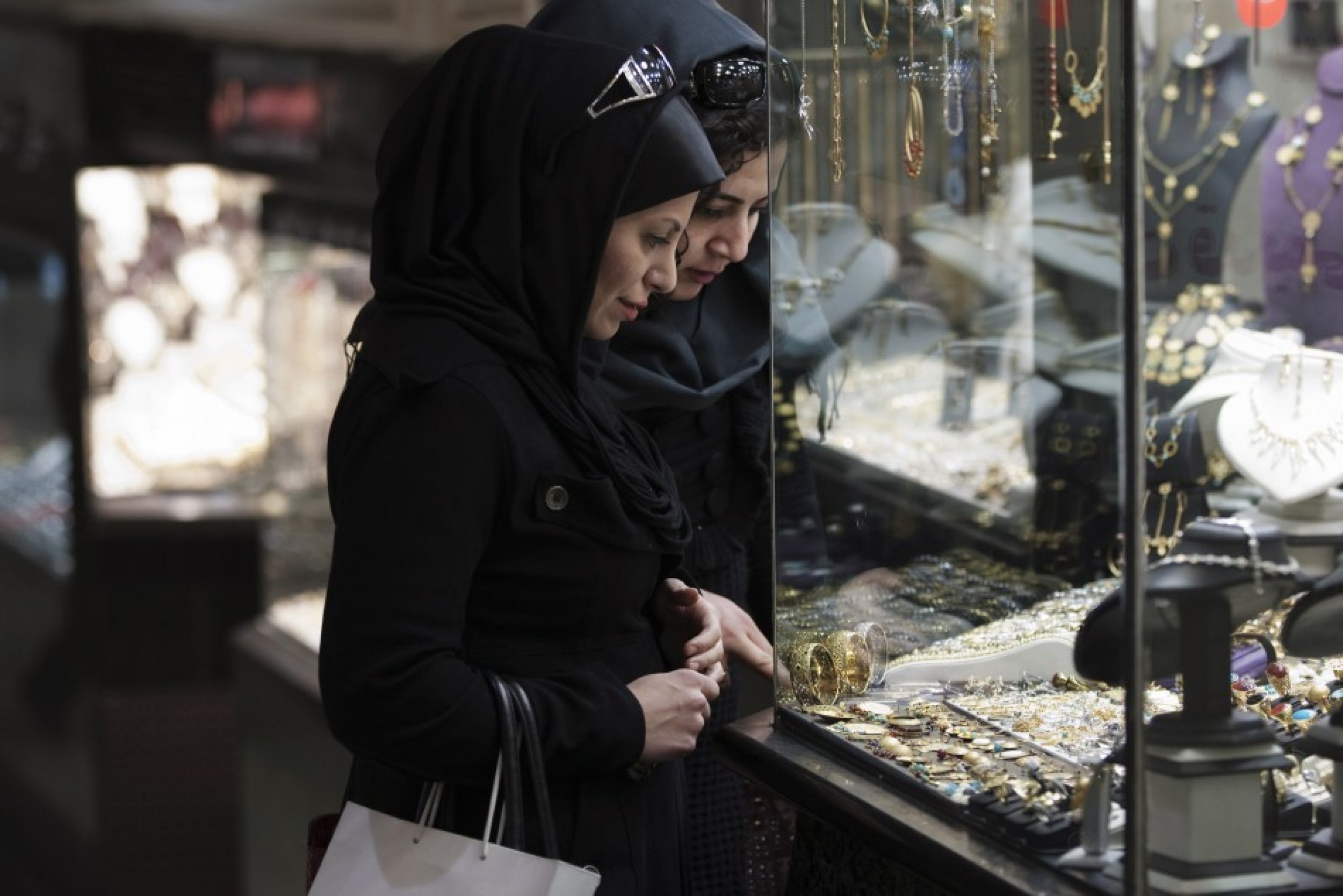 Women look at jewelry while shopping in Tehran