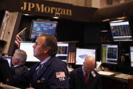 Traders work in the JP Morgan company stall on the floor of the New York Stock Exchange in New York