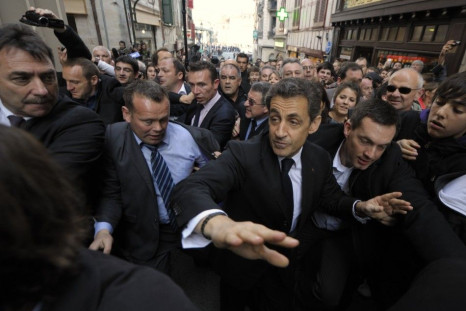 Nicolas Sarkozy, France&#039;s President and UMP party candidate for the 2012 French presidential election, walks in the street protected by plain-clothes policemen during a campaign trip in Bayonne.