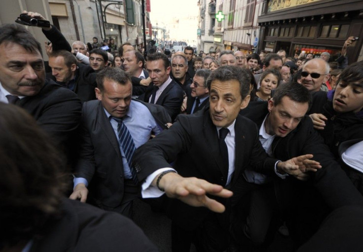 Nicolas Sarkozy, France&#039;s President and UMP party candidate for the 2012 French presidential election, walks in the street protected by plain-clothes policemen during a campaign trip in Bayonne.