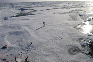 A member of a team of Cambridge scientists trying to find out why Arctic sea ice is melting so fast, walks on some drift ice 500 miles (800 km) from the North Pole September 3, 2011.