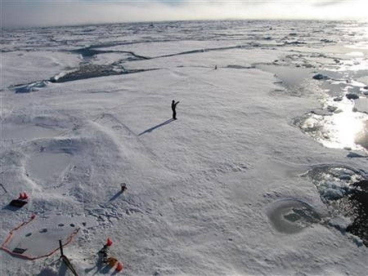 A member of a team of Cambridge scientists trying to find out why Arctic sea ice is melting so fast, walks on some drift ice 500 miles (800 km) from the North Pole September 3, 2011.