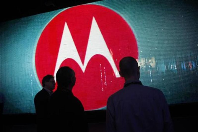 Visitors look at a video display at the Motorola booth on the second day of the Consumer Electronics Show (CES) in Las Vegas