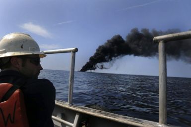 Adam Shaw, a Louisiana oilfield diver assigned to the Premier Explorer, performs a surveillance mission during a controlled fire of the oil-covered waters in the Gulf of Mexico May 7, 2010. The U.S. Coast Guard working in partnership with BP PLC, local re
