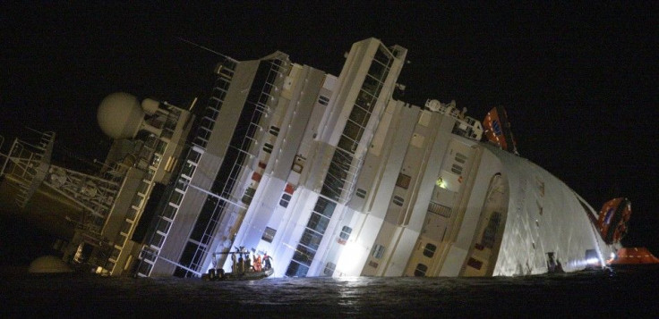 Rescuers are seen next Costa Concordia cruise ship that ran aground off the west coast of Italy at Giglio island January 14, 2012.