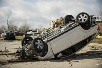 Courtesy of the Indiana National Guard, a handout photo shows a vehicle flipped over by a tornado in Henryville, Ind., March 3, 2012.