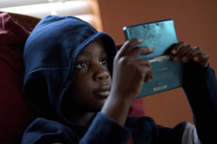Jamal Stevens, 7, plays a video game at his grandparent&#039;s home in Charlotte.