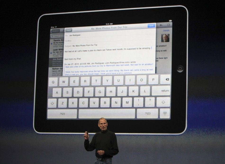 Apple CEO Steve Jobs shows the keypad on iPad tablet during launch in San Francisco