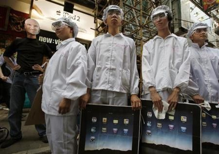 A protester wearing a mask of Apple Inc founder Steve Jobs performs a street drama with local and mainland Chinese university students playing the role of Foxconn workers during a protest in Hong Kong May 7, 2011. A workers&#039; concern group demonstrate