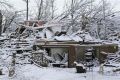 Snow covers a storm-damaged home in Henryville, Indiana, March 5, 2012.
