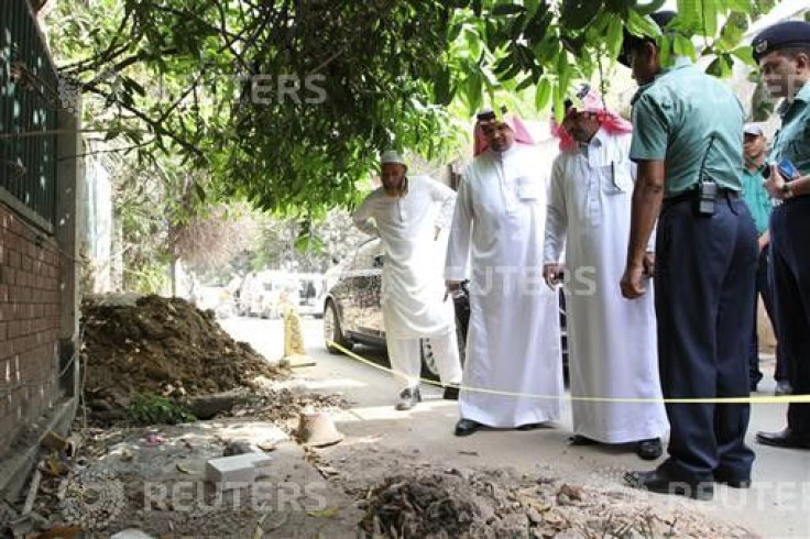 Police and officials from the Saudi Arabian embassy in Bangladesh inspect the spot where Khalaf Al Ali was shot dead in Dhaka