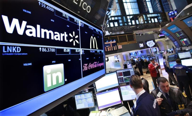 A board shows stock prices for Walmart, Linkedin, McDonald's and Coca-Cola at the booth they are traded on the floor of the New York Stock Exchange