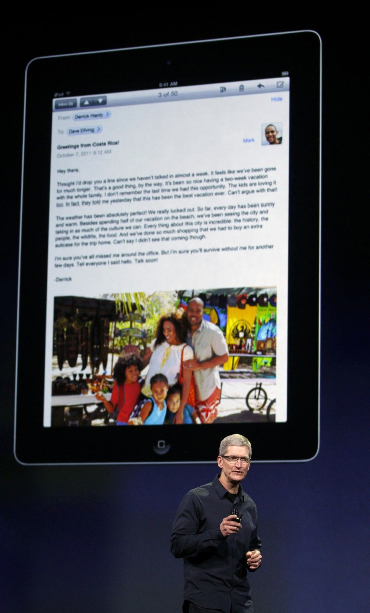 Apple CEO Cook speaks during an Apple event as an image of the old iPad is projected on the screen behind him in San Francisco