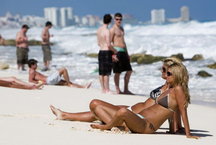 Tourists relax on a mexican beach in spite of warnings about violence